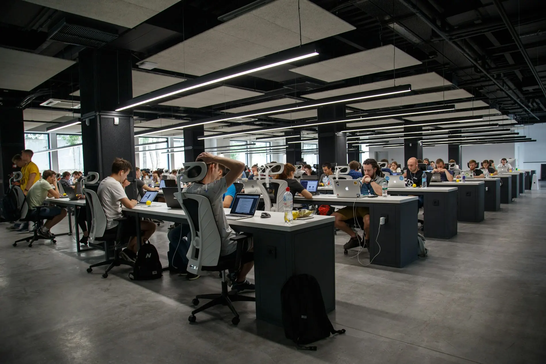 A large open-plan office with teams at work