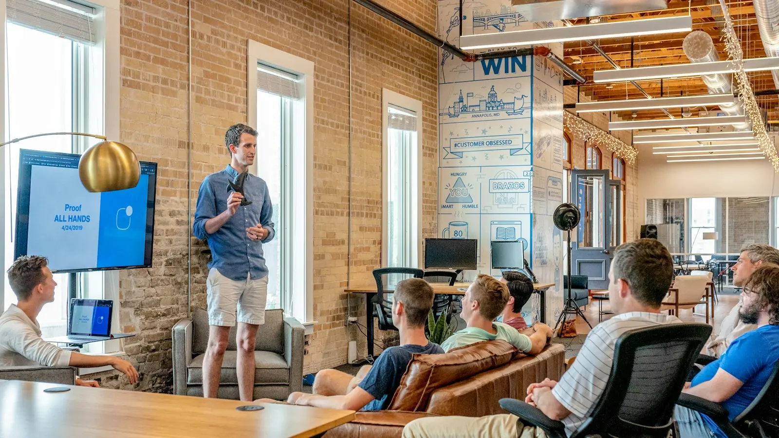 A presenter sharing ideas with a team in a modern office